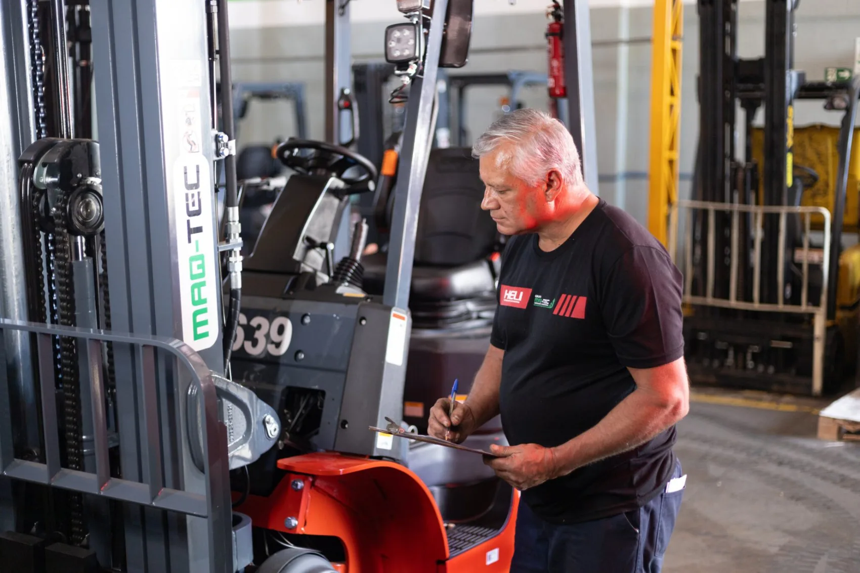 Técnico Maq-Tec inspecionando empilhadeira